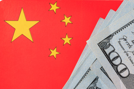 Chinese flag and us dollars symbolizing economic exchange and trade relations.の写真素材