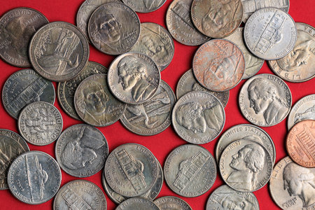 Assorted vintage united states coins on red background.の写真素材