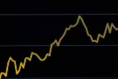 Yellow display of an increasing data line graph with a sharp decline on black background.