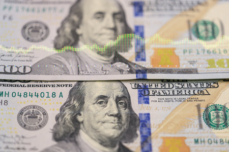 Us dollar banknotes with financial graph overlay.