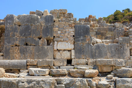 Antique wall made of huge blocks with minimal gaps. Background with selective focus and copy space...