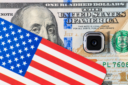 Us flag overlapping hundred dollar bill with credit card chip.の写真素材