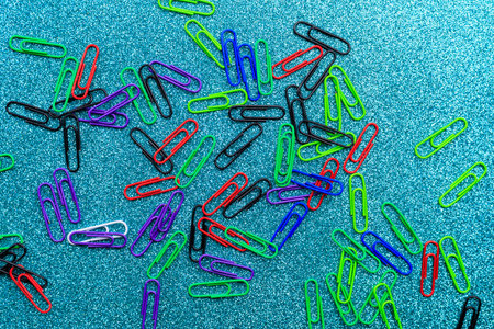 Multi-colored office paper clips. Background with selective focus and copy space for textの写真素材