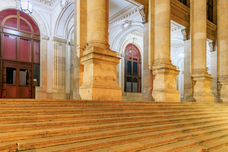 Grand entrance of historic building with majestic columns at night.の写真素材