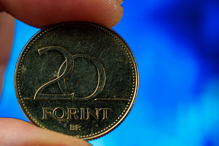 Close-up of hungarian 20 forint coin against blue background.の写真素材