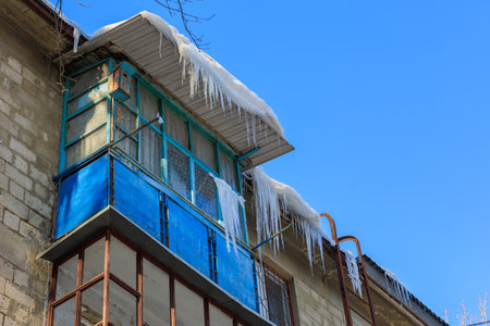 Large icicles on the roof. Background with selective focus and copy space for textの写真素材