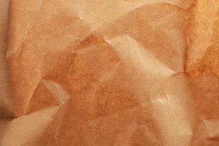 Brown wrinkled paper texture with folds and crumples.の写真素材