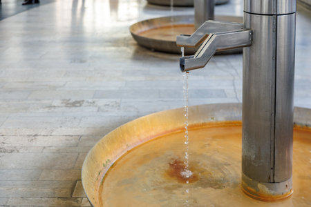 Modern public water fountain with flowing water in urban setting.の写真素材