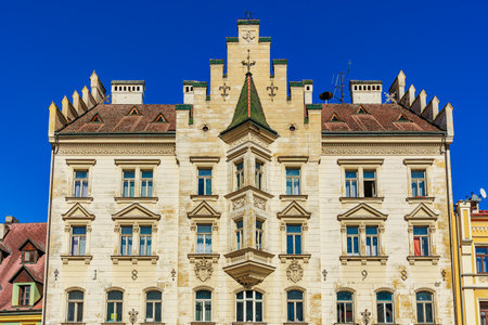 Historic european building with ornate architecture and symmetrical design against clear blue sky.の写真素材