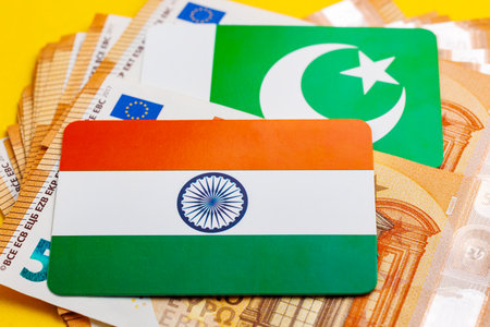 Indian and pakistani flags on euro banknotes representing economic relations.の写真素材