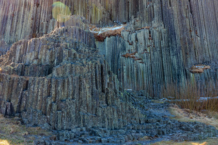 Majestic columnar basalt rock formation in natural landscape.の写真素材