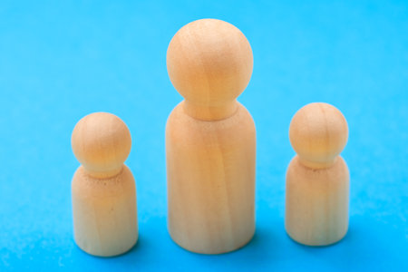 Wooden peg dolls family on blue background.の写真素材