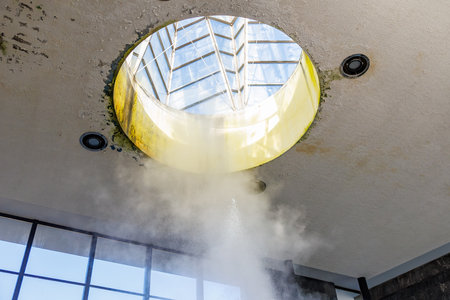 Abstract skylight with visible steam underneath circular architecture.