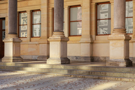 Classical architecture with stone columns and glass windows.