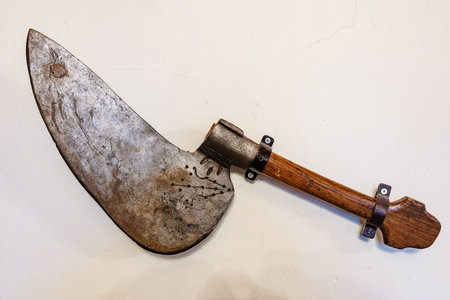 Vintage rustic meat cleaver with wooden handle on white background.