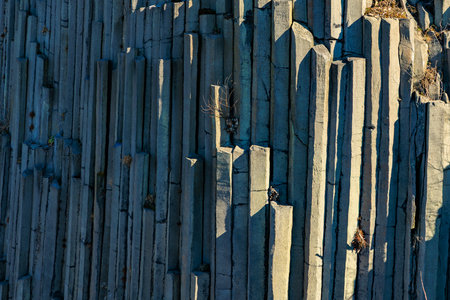 Stunning geometric basalt columns captured in natural sunlight.の写真素材
