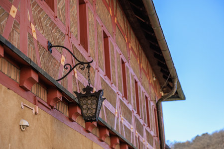 Rustic half-timbered house with lantern on a clear day.の写真素材