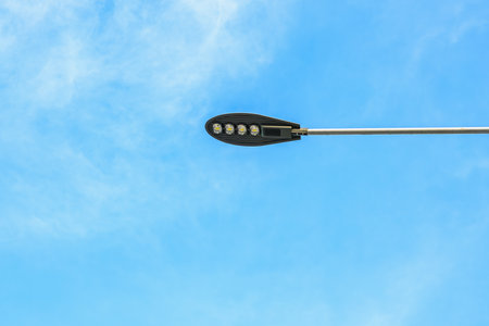 Streetlight against clear blue sky on a sunny day.の写真素材