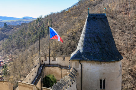Scenic view of czech flag on historic castle tower amidst forested hills.の写真素材