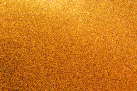 A gold background with a lot of small gold dots. The background is a rich, warm gold color that...