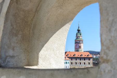 Historic cesky krumlov castle tower framed through stone archway.の写真素材
