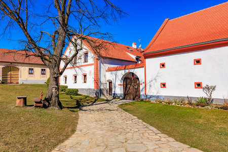 Charming european countryside house with red roof and stone path.の写真素材