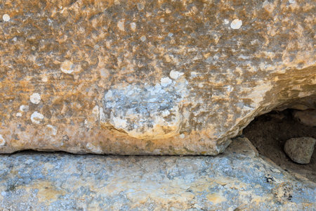 Antique wall made of huge blocks with minimal gaps. Background with selective focus and copy space for textの写真素材