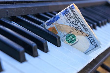 A keyboard with a $100 bill in the middle. Concept of curiosity and intrigue, as the viewer wonders...