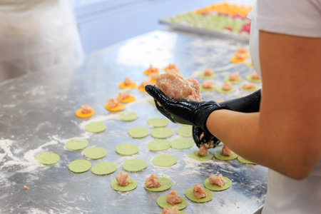 Factory for making dumplings from dough and minced meat. Background with selective focus and copy space for textの写真素材