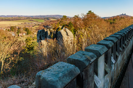 Panoramic view of autumn landscape with historic stone wall and rock formations.の写真素材