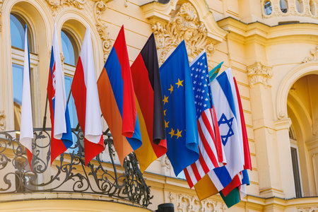 International flags displayed on european building balcony.の写真素材