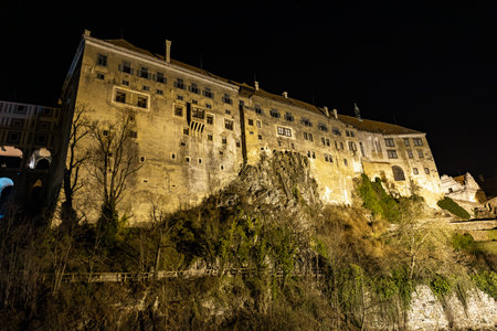 Historic night view of cesky krumlov castle illuminated against night sky.の写真素材
