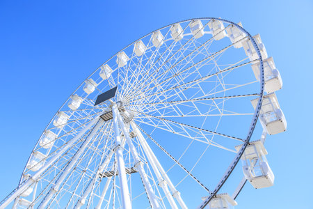 Giant ferris wheel against clear blue sky on a sunny day.の写真素材