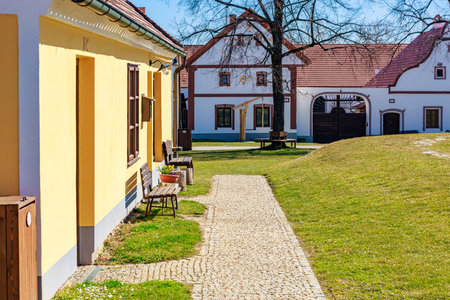 Charming village pathway with historical european architecture on a sunny day.の写真素材