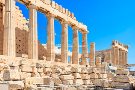 A large building with columns and a blue sky in the background. The building appears to be ancient and has a sense of grandeur and history. The blue sky adds a sense of tranquilityの写真素材