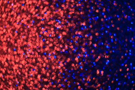 A vibrant and dynamic background with a multitude of small, colorful dots. The red and blue hues create a striking contrast that draws the viewer's attentionの写真素材