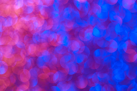 The image is a blurry, colorful background with blue and pink tones. The background is filled with...