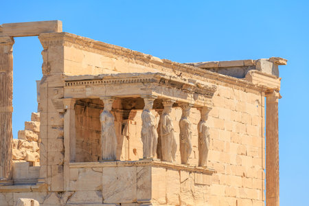 The building has a lot of statues on it. The statues are of women and they are all standing...