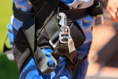 Close-up of safety harness and carabiner on caucasian adult male.の写真素材