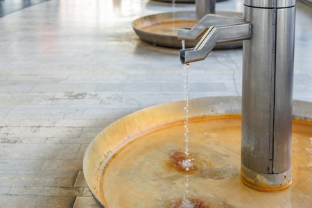 Modern water fountains with stainless steel architecture in urban setting.の写真素材
