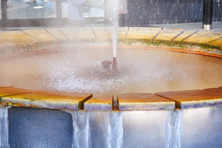 Geothermal spa fountain with mineral deposits and bubbling water, natural geyser.の写真素材