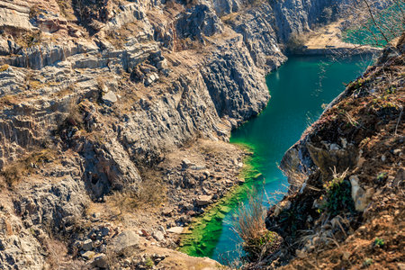 Serene sapphire waters amidst rocky cliffs in picturesque natural canyon landscape.の写真素材