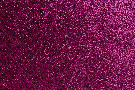 A close up of a purple glittery surface. The surface is covered in small, shiny, colorful specks. The image has a dreamy, ethereal quality to it, as if it were a painting or a photographの写真素材