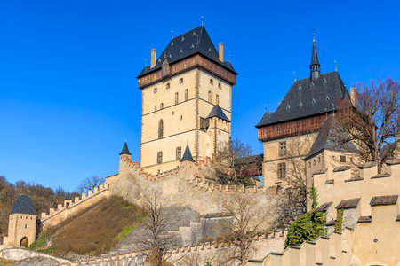 Historic Karlstejn castle against clear blue sky.の写真素材