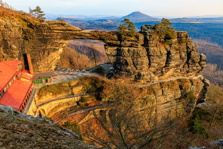 Majestic sandstone arch in saxon switzerland national park at sunrise.の写真素材