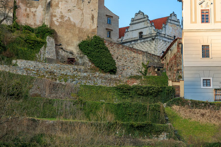 Historic european architecture with stone walls and ivy-covered terraces.の写真素材