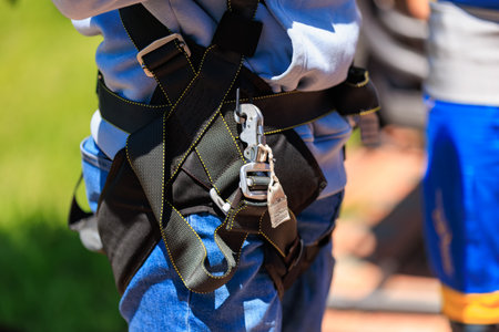 Close-up of safety harness on young caucasian male ready for outdoor adventure.の写真素材
