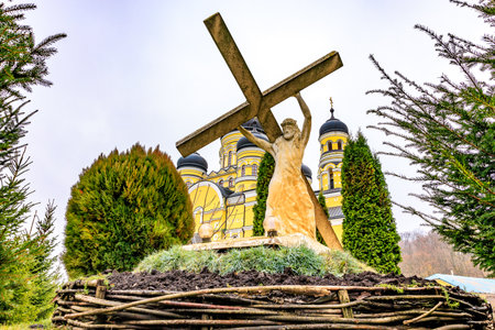 Sculpture Jesus Christ carrying his cross, old monastery Hincu in Moldova. Background with selective...