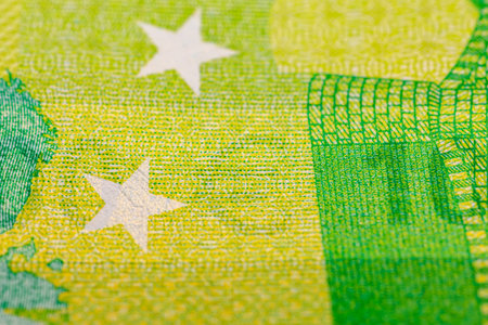 Close-up of a euro banknote with green and yellow patterns.の写真素材