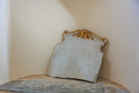 Ornate stone tablet in corner of historical room.の写真素材